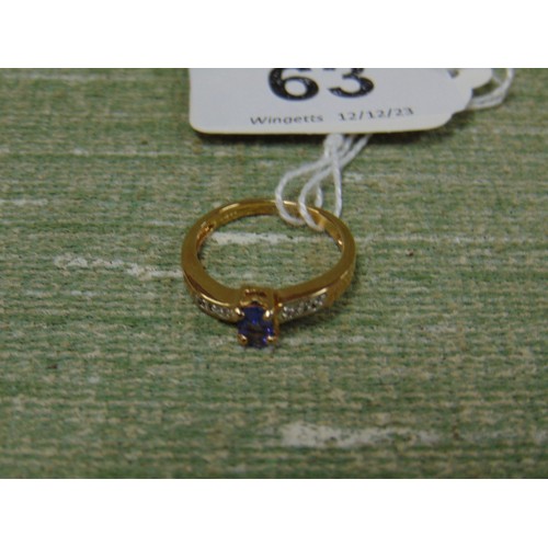 63 - 9 K Tanzanite and diamond yellow gold ring, size N.