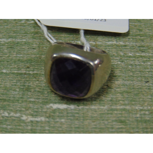 107 - Silver ring set with purple stone, size P.