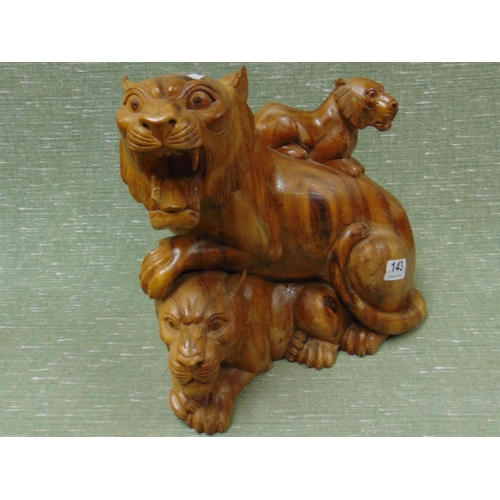 143 - Carved hardwood figure group, tigress and her cubs. 12