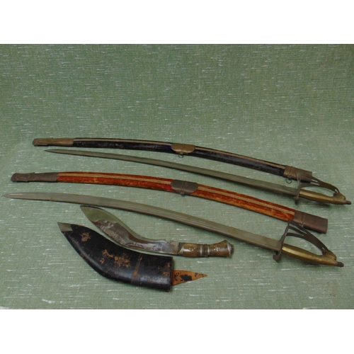 153 - Two ornamental swords and a Kukri knife.