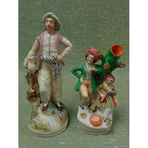 199 - 19th century Staffordshire figure, man holding a jug, and a spill vase. (2)