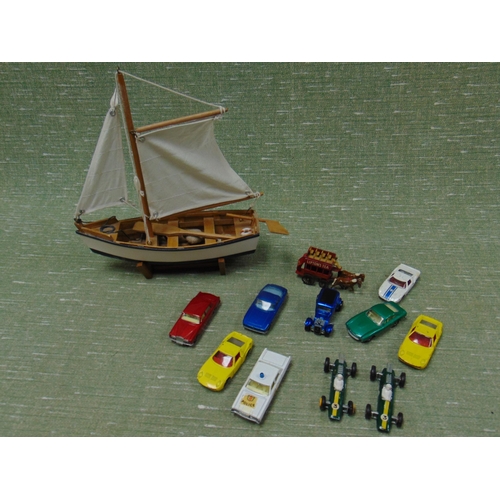 257 - Small quantity of collectable model vehicles and a small model boat.