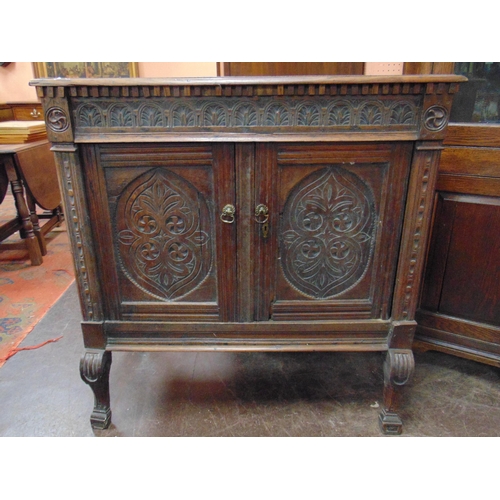 366 - Antique oak cupboard, carved frieze and pair of doors enclosing a shelf lined interior, on frontal s... 