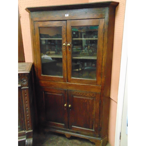 368 - Antique oak freestanding corner cupboard, ogive cornice above pair of glazed doors, further doors to... 