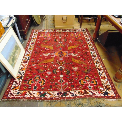 377 - Persian red ground rug, having geometric bird pattern, 76 x 58