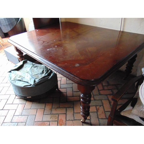 412 - Victorian mahogany extending dining table, rounded corners, on turned supports and castors, with two... 