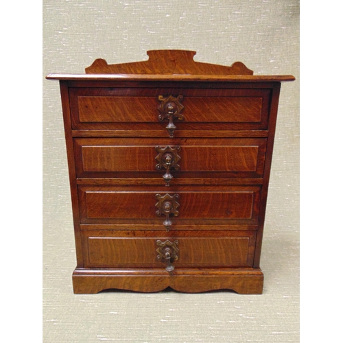 15 - An Edwardian oak table top chest, having raised back, four drawers with metal drop handles and on pl... 