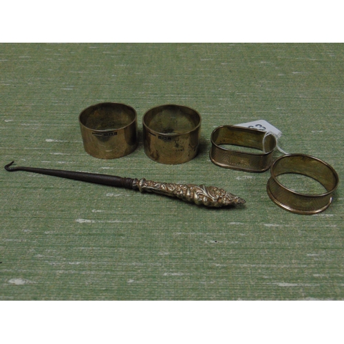 163 - Pair of silver napkin holders, two others and a possibly silver handled button hook.