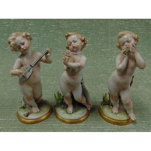 173 - Group of three Capodimonte cherub figures, set on naturalistic bases, af.