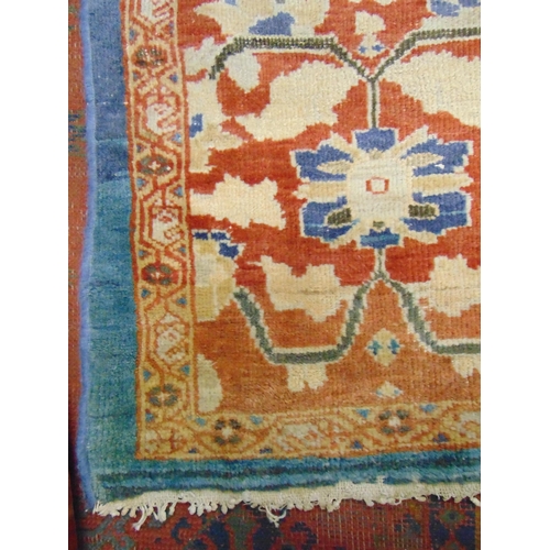 367 - Large red and blue ground rug, having geometric floral pattern, 179 x 129