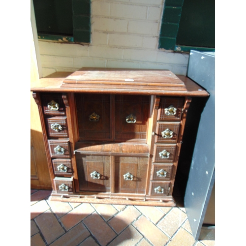 469 - An antique sewing machine, contained in a walnut cabinet.