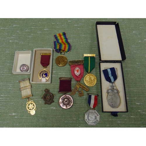 151 - Four Masonic medals, fire Brigade long service medal, jubilee medal, Northumberland hussars cap badg... 