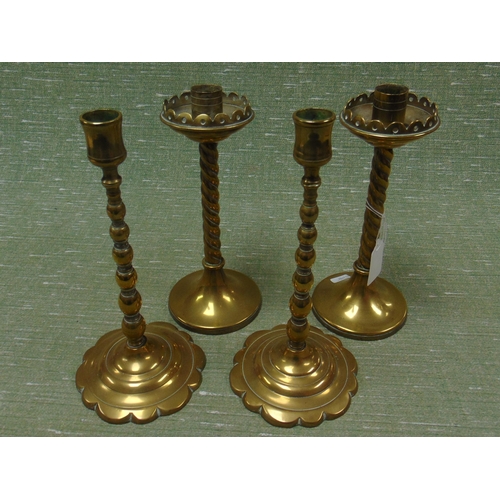 176 - Two pairs of antique brass candlesticks.