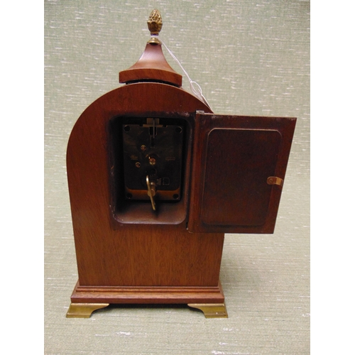 188 - Reproduction marquetry inlaid mantle clock, having Roman numerals, gilt pineapple finial, lion mask ... 