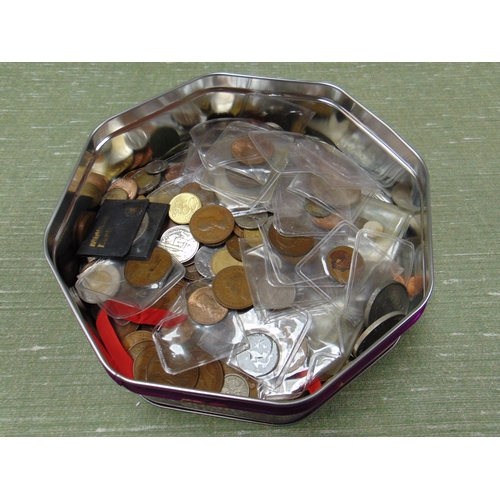 28 - A tin of coins.