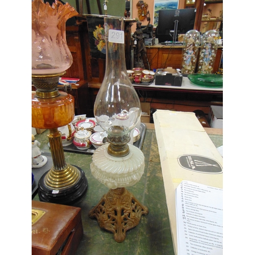 291 - Antique oil lamp, opaque reservoir and on cast iron base.