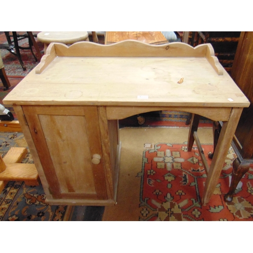 332 - Pine child's desk, raised back and single cupboard door. 28 x 34 x 19