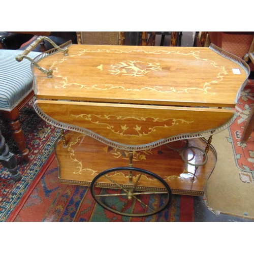 338 - Ornate reproduction marquetry inlaid two tier drinks trolley.