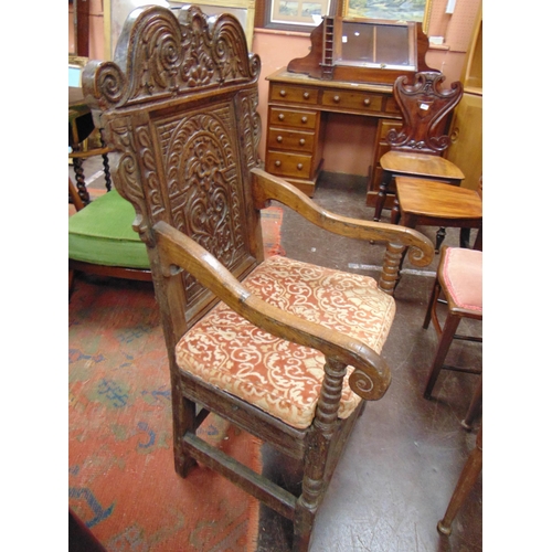 342 - Antique oak wainscot chair, shaped top above carved decoration, scroll arms, solid seat, set on balu... 