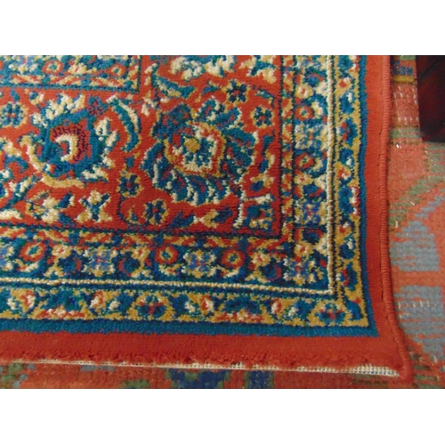 348 - William Morris influenced rug, having blue and red geometric pattern. 112 x 79