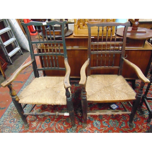 351 - Matched pair of elm spindle back country made arm chairs, having basket weave seats, on turned suppo... 