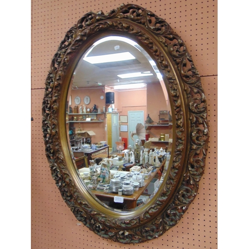 363 - Ornate oval bevel edged wall mirror. 35 x 27