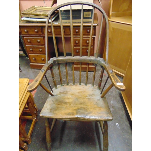 429 - Antique elm hoop back Windsor chair, open arms, solid seat, on turned supports and stretchers.