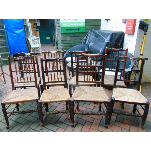 448 - Harlequin set of eight elm rush seated country made chairs.