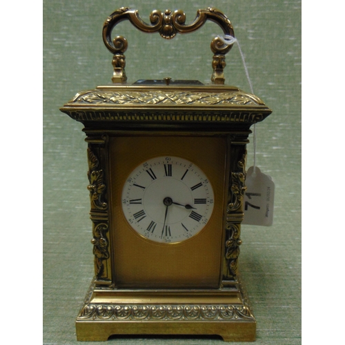 71 - Ornate French brass cased carriage clock, having moulded decoration, enamel face and Roman numerals.... 