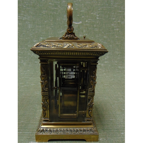 71 - Ornate French brass cased carriage clock, having moulded decoration, enamel face and Roman numerals.... 