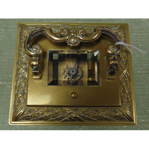 71 - Ornate French brass cased carriage clock, having moulded decoration, enamel face and Roman numerals.... 