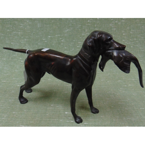 162 - Bronze style figure, modelled as a gun dog holding a bird in his mouth. 9 x 15