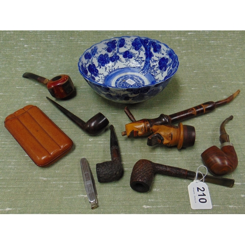 210 - Collection of tobacco pipes, smoking paraphernalia, contained in an oriental blue glazed bowl.