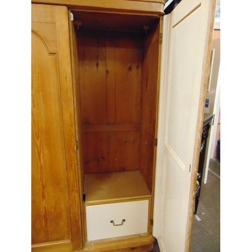 380 - Victorian pine triple wardrobe, ogive cornice above arched panels, fitted interior and on platform b... 