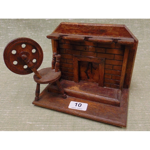 10 - Novelty pipe rack in the form of a hearth  with a spinning wheel. 8