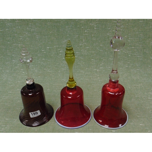 199 - Two Victorian cranberry glass bells, and one other example. (3)