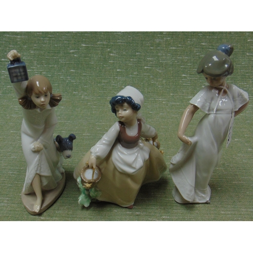 211 - Three Nao figurines.