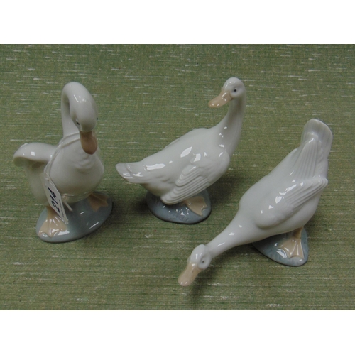 214 - Three Nao geese figures.