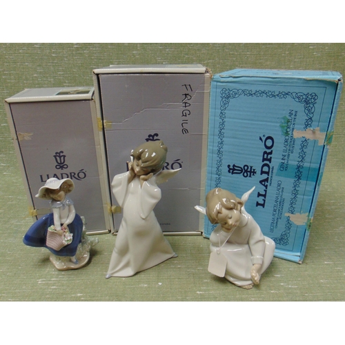 298 - Two boxed Lladro cherub figures and one other example.