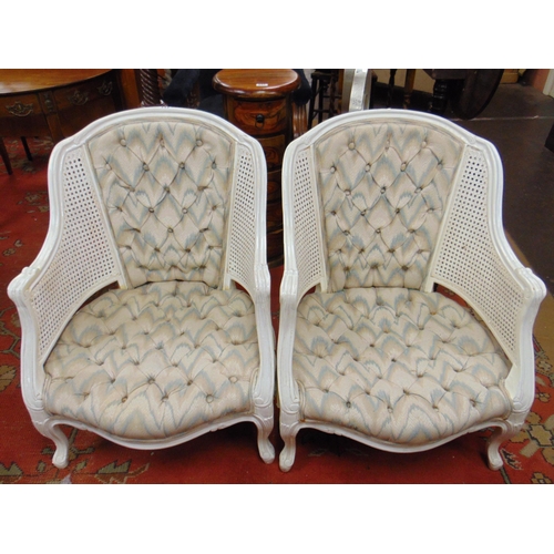 332 - Pair of painted bergere tub chairs, having upholstered backs and seats, on frontal cabriole supports... 