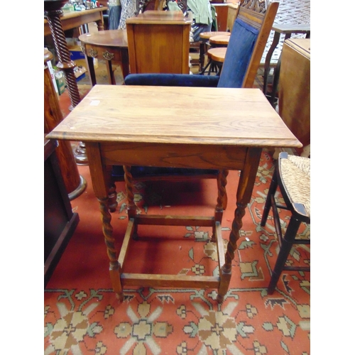 335 - An oak centre table, set on barley twist supports.