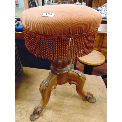 358 - Victorian revolving piano stool , upholstered top, on foliate moulded downswept supports.