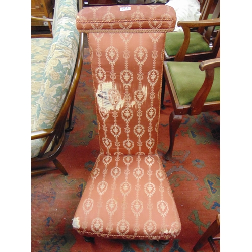 373 - Victorian prie dieu chair, having all over upholstery, on short turned supports with castors.