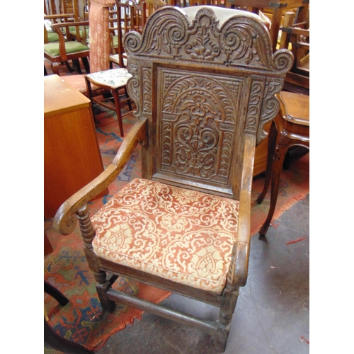 375 - Antique oak wainscot chair, shaped top above carved decoration, scroll arms, solid seat, set on balu... 