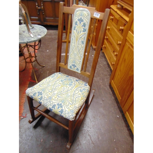 378 - Edwardian beech framed rocking chair, having upholstered back and seat.