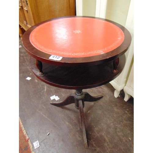 412 - Red leather topped revolving centre table.