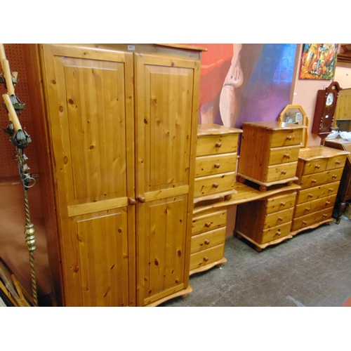 417 - Modern pine bedroom suite, comprising double door wardrobe, dressing table, mirror, chest of drawers... 