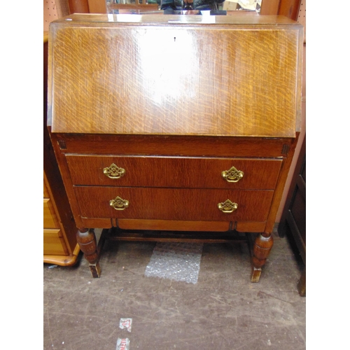 420 - An oak bureau, fall front above two long drawers with gilt metal handles, on cup and cover supports.... 