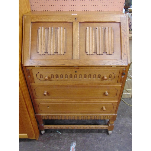 427 - Oak bureau, linenfold fall front, revealing a fitted interior, three long drawers on short turned su... 