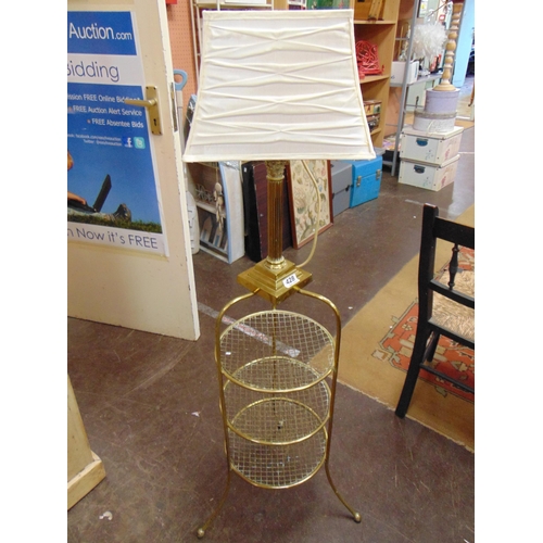 428 - Brass table lamp, set on a three tier wot not. 48